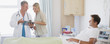 Doctor reviewing medical chart with patient?s wife in hospital