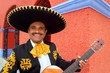 Photo : Charro Mariachi playing guitar Mexico houses Charro Mariachi playing guitar Mexico houses