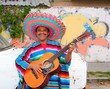 Photo: Mexican humor man smiling playing guitar sombrero Mexican humor man smiling playing guitar sombrero