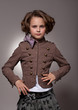Serious stylish little girl looking at camera