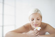 Woman on massage table smelling orchid