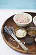 Bath salts and massage oils in bowls on tray