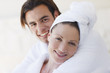 Couple in bathrobes hugging