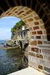 Traditional house on a tropical beach through a cave, Greece