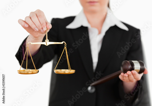 Foto: Woman holding a gavel and scales of justice Woman holding a gavel and scales of justice