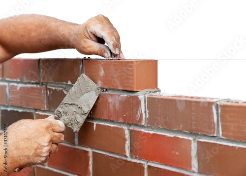 Photo: Bricklaying isolated on white Bricklaying isolated on white