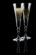 Two glasses of sparkling wine (champagne) on black