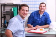 two male colleagues sat in an office