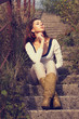 Attractive brunette woman sitting on the stairs