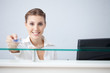 Smiling receptionist holding health insurance card