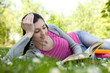 woman listening music and reading book in park woman listening music and reading book in park