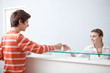 Boy giving receptionist health insurance card
