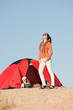 Camping happy woman outside tent on beach Camping happy woman outside tent on beach