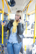 junge blonde frau mit smartphone im bus junge blonde frau mit smartphone im bus