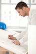 Young engineer making plans