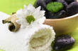 Spa,  flower on the towel, and a bowl with black stones