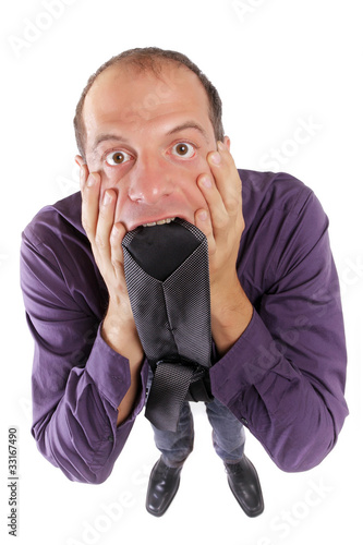 Photo: frustrated business man biting necktie frustrated business man biting necktie