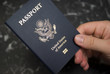 Photo: Hand holding American passport Hand holding American passport