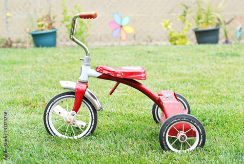 Photo: Old Red Kids Bike on The Grass Old Red Kids Bike on The Grass