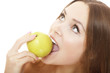 Photo: Pretty girl with open mouth eating green ripe apple Pretty girl with open mouth eating green ripe apple