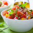 Summer rice salad with vegetables and fresh herbs