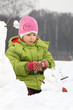 Girl sculp from snow much snowman