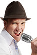 Man in brown felt  hat sings expressively into microphone