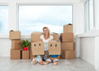 Woman with playing kids in their new home