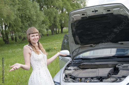 Photo: Worried woman with broken car Worried woman with broken car