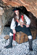 Photo: Pirate siting on treasure trunk Pirate siting on treasure trunk