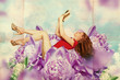 beautiful woman with book in flowers