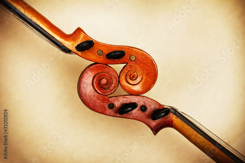 Photo: two old violin scrolls detail in ambient light two old violin scrolls detail in ambient light