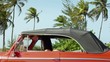 female friends driving and pushing broken down old car