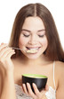 Photo: portrait of young caucasian woman eating cereals portrait of young caucasian woman eating cereals