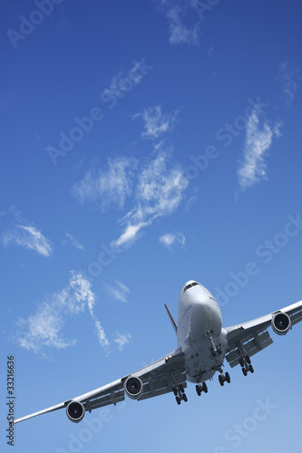 Photo: Jet aircraft is maneuvering in a blue sky Jet aircraft is maneuvering in a blue sky
