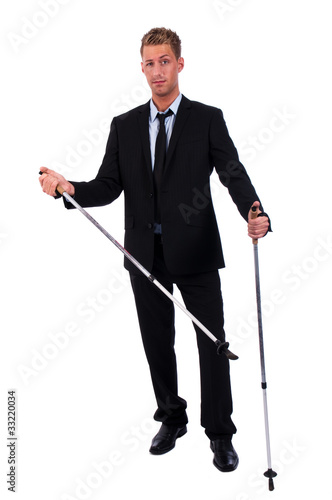 Photo: young businessman with nordic walking sticks young businessman with nordic walking sticks