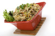 Pancit in a red ceramic dish