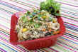 Pancit in a red ceramic dish