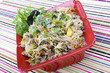 Pancit in a red ceramic dish