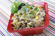 Pancit in a red ceramic dish