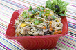 Pancit in a red ceramic dish