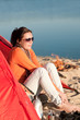 Camping beach woman by campfire in tent