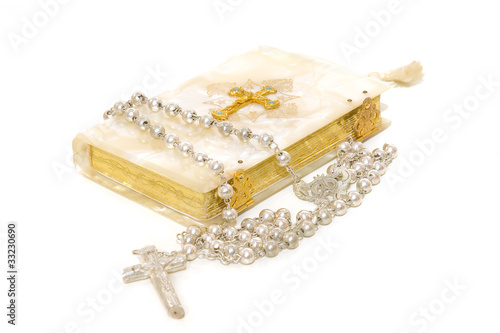 Photo: Rosary and First Communion book isolated on white background Rosary and First Communion book isolated on white background
