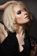 Sexy blond woman model in lacy black dress, with gloss make-up