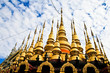 golden tample with blue sky and white crown