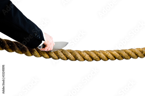 Photo: businessman cutting rope businessman cutting rope