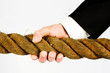 businessman hand gripping rope