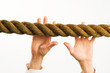 hands reaching to rope