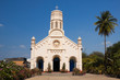 Pastel yellow church against blue sky Pastel yellow church against blue sky