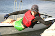 Young woman dinghy sailing at regatta